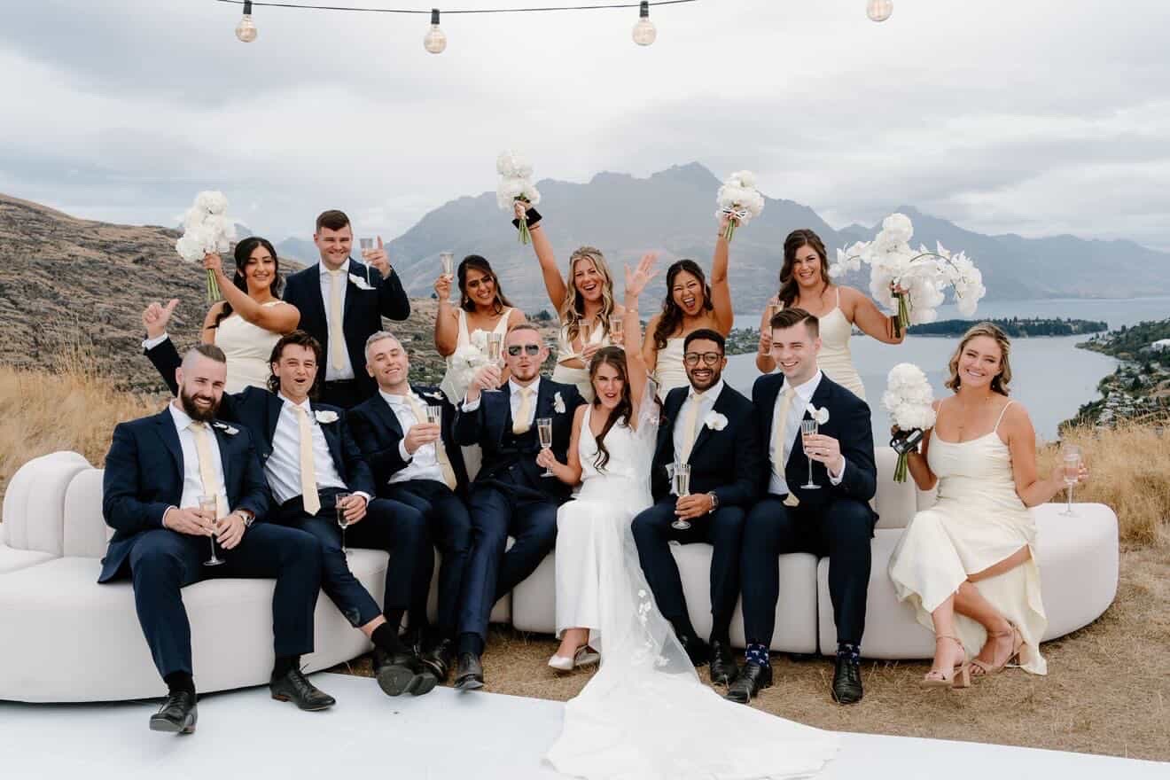 The whole bridal party celebrating on the hill