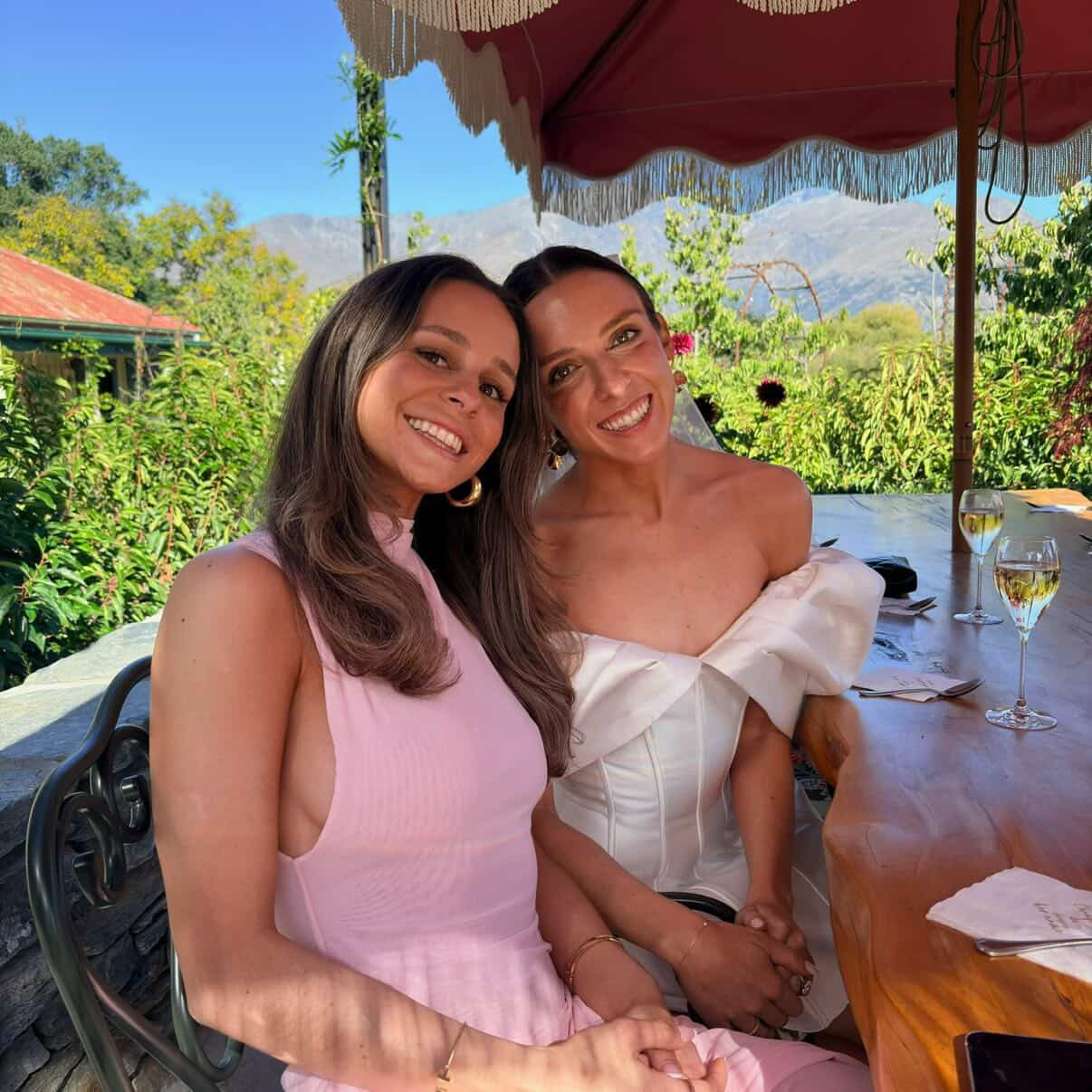 Bride and friend celebrating in the garden