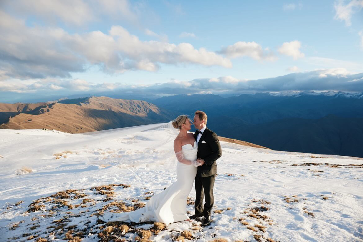 Bride and groom on the snow-covered mountaintop