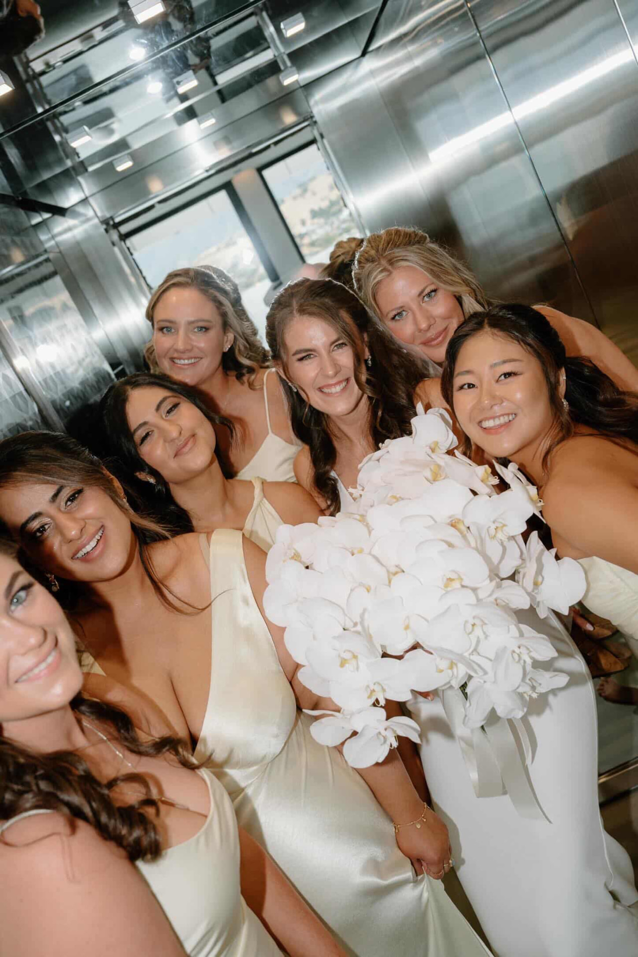 Bride and bridesmaids squeezed into the elevator