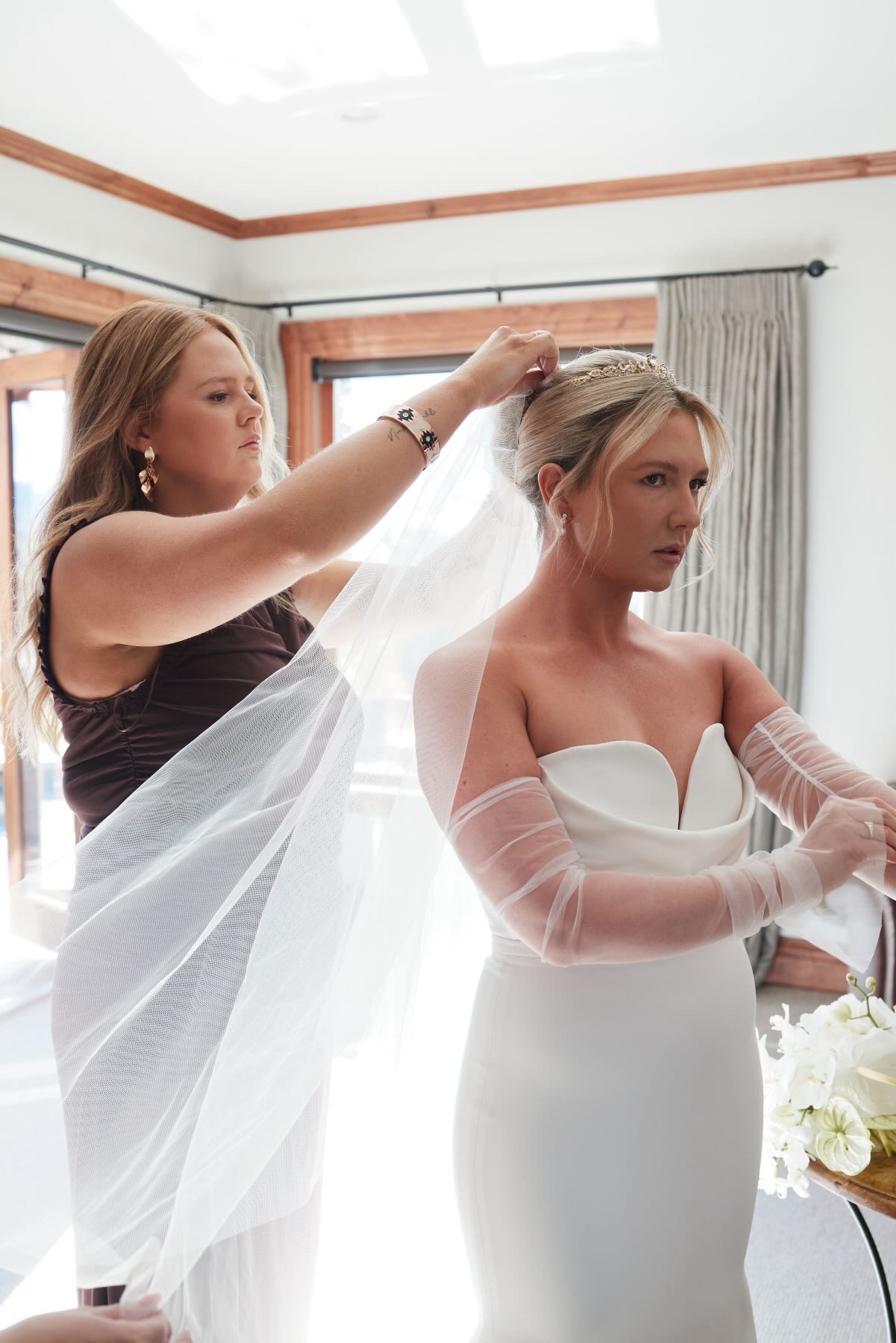 Bridesmaid placing the bride's veil